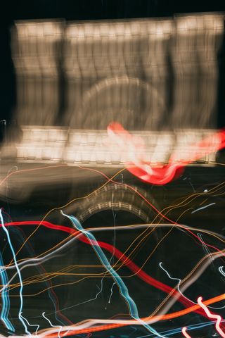 Blurred, abstract photo of the Grand Army Plaza Arch with colorful light trails