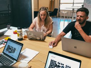 Lindsay Rife (left) and Ethan Leon working on laptops