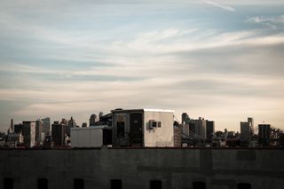 Building roof with city skyline in background